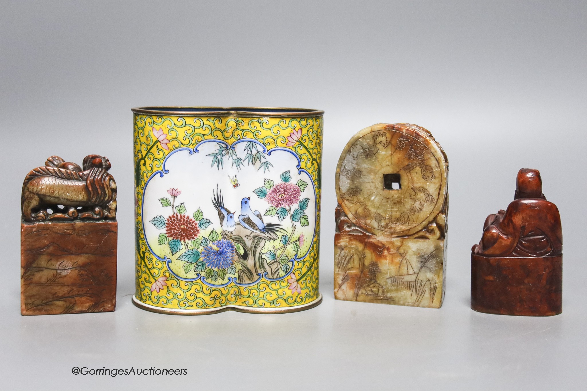 A Chinese enamel on copper brush pot together with three soapstone seals, 10cm